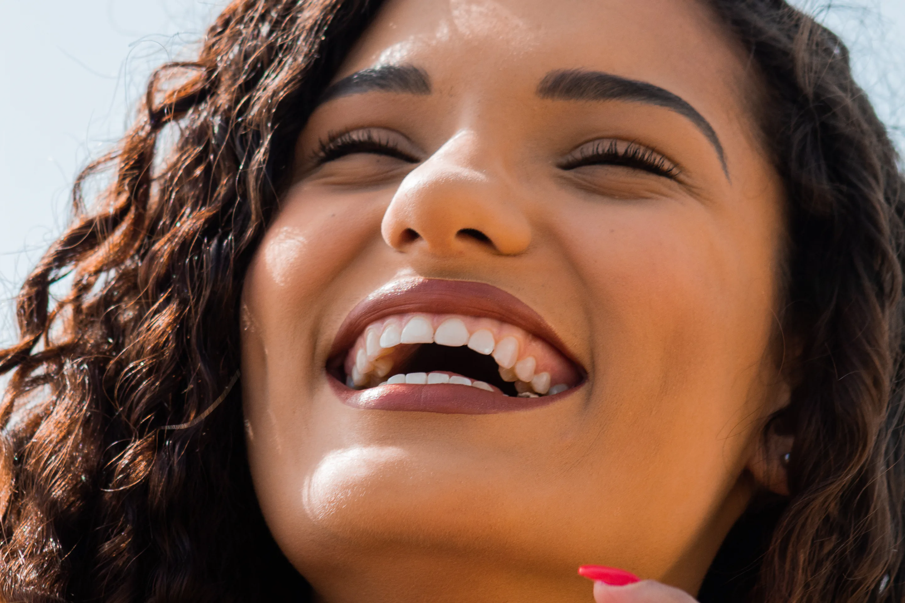 A woman laughing in the sun